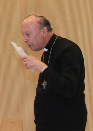 Belgian Archbishop of Mechelen-Brussels and Primate of Belgium Leonard reacts after activists from women's rights group Femen sprayed water at him during a conference at Brussels university ULB